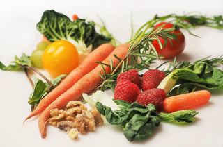 Pflanzenbasierte Lebensmittel wie Gemüse, Beeren und Nüsse als Symbol für basische Ernährung, Säure-Basen-Haushalt und gesunde Essgewohnheiten